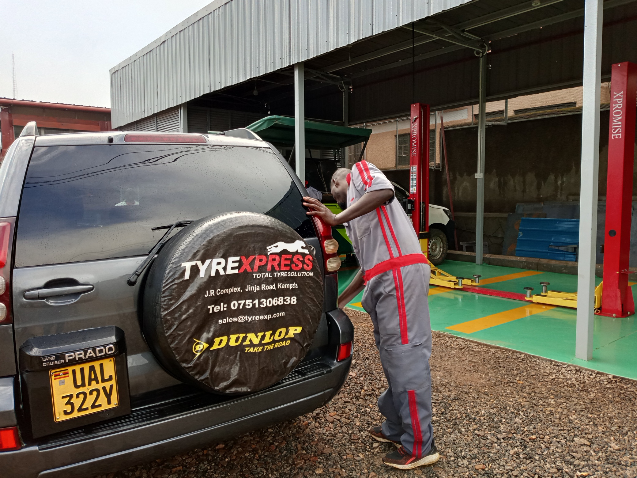 Technician fitting a spare wheel